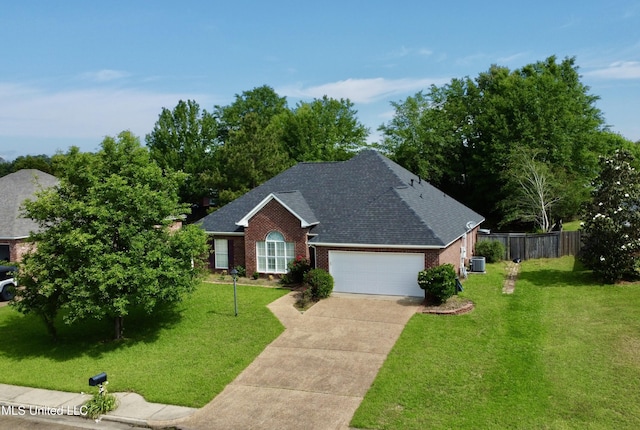 ranch-style home with a front lawn, fence, brick siding, a shingled roof, and driveway