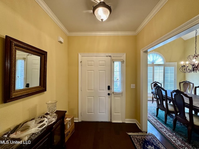 entryway with crown molding, a wealth of natural light, a chandelier, and dark wood-type flooring