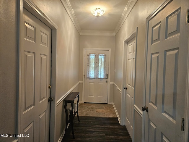 doorway featuring ornamental molding and dark hardwood / wood-style floors