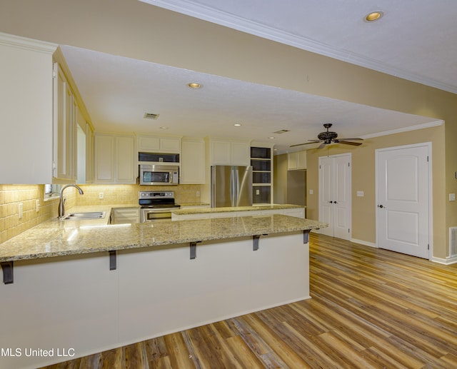 3099 E Fairway Dr, Brandon, MS 39047 - kitchen featuring a sink, appliances with stainless steel finishes, backsplash, light stone counters, and recessed lighting