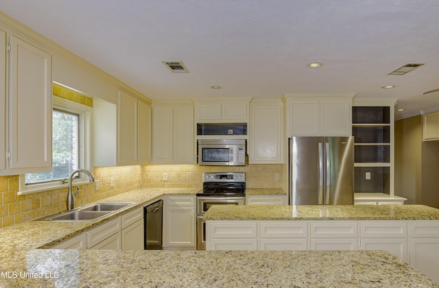 3099 E Fairway Dr, Brandon, MS 39047 - kitchen with stainless steel appliances, a sink, light stone counters, tasteful backsplash, and recessed lighting