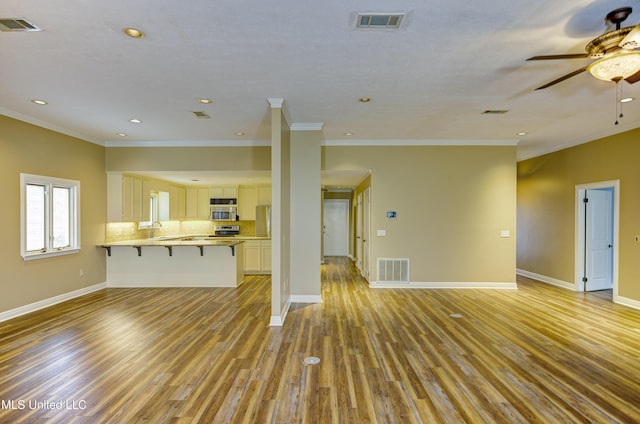 3099 E Fairway Dr, Brandon, MS 39047 - unfurnished living room featuring light wood-style floors, ceiling fan, a sink, crown molding, and recessed lighting