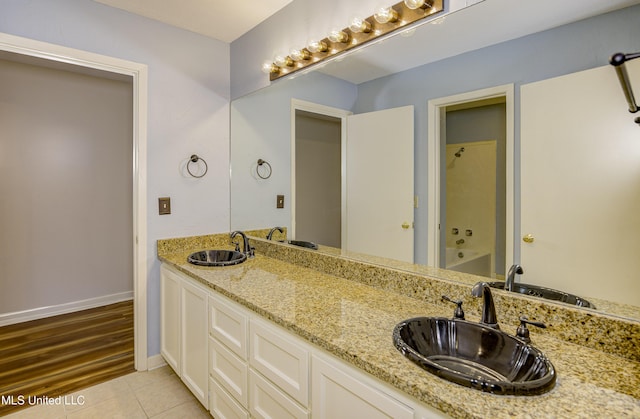 3099 E Fairway Dr, Brandon, MS 39047 - bathroom featuring tile patterned floors, double vanity, baseboards, and shower / bathtub combination