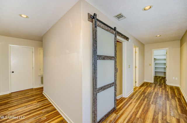 3099 E Fairway Dr, Brandon, MS 39047 - corridor featuring a barn door, wood finished floors, recessed lighting, and baseboards