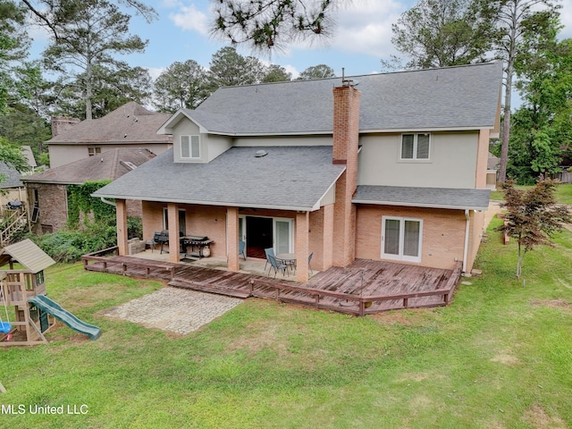 3099 E Fairway Dr, Brandon, MS 39047 - rear view of house with a shingled roof, a chimney, a yard, a deck, and stucco siding