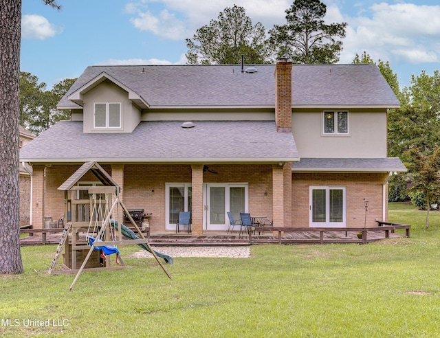 3099 E Fairway Dr, Brandon, MS 39047 - back of house featuring a lawn, a shingled roof, a chimney, and ceiling fan