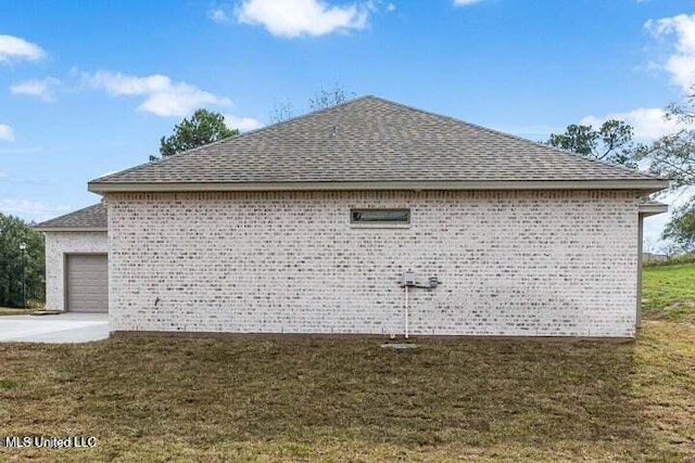 view of home's exterior with a yard and a garage