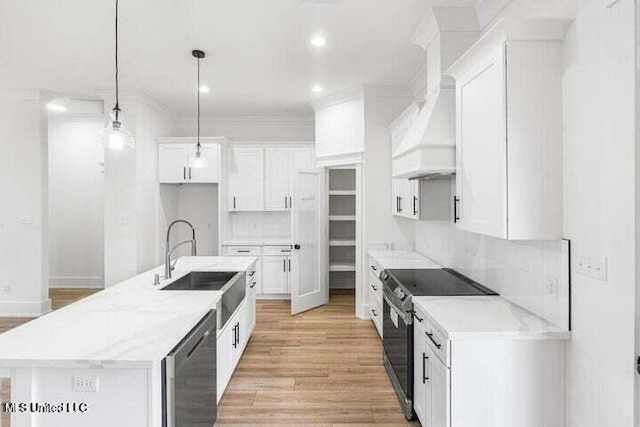 kitchen featuring white cabinets, pendant lighting, decorative backsplash, and electric stove