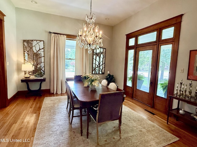 101 E E President, Greenwood, MS 38930 - dining room with light wood-style flooring and a chandelier