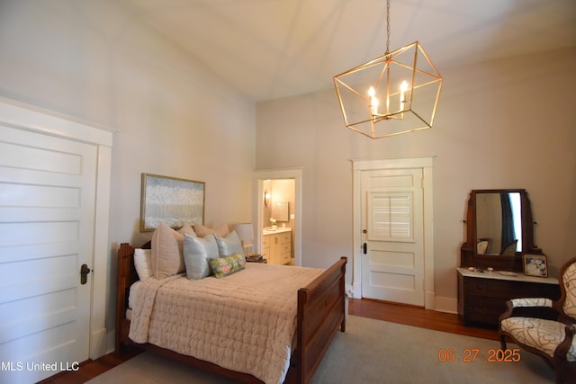101 E E President, Greenwood, MS 38930 - bedroom featuring high vaulted ceiling, a chandelier, wood finished floors, and ensuite bath