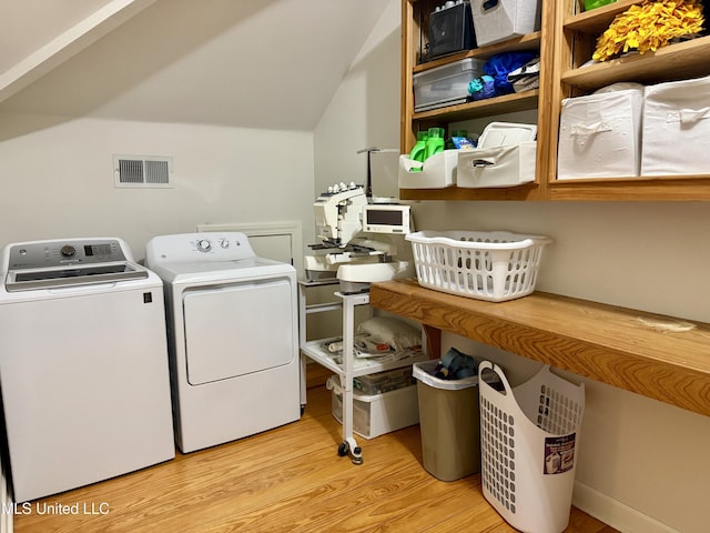 101 E E President, Greenwood, MS 38930 - washroom featuring washing machine and clothes dryer and wood finished floors
