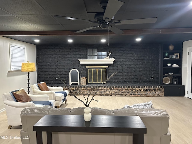 1529 Ticonderoga Dr, Southaven, MS 38671 - living area with wood finished floors, a ceiling fan, and brick wall
