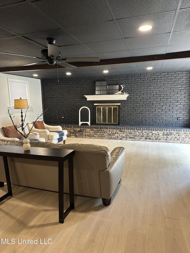 1529 Ticonderoga Dr, Southaven, MS 38671 - living room featuring a paneled ceiling, wood finished floors, brick wall, and ceiling fan