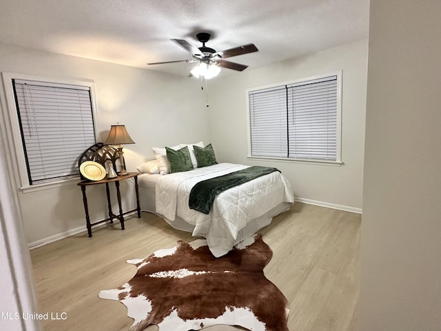 1529 Ticonderoga Dr, Southaven, MS 38671 - bedroom with wood finished floors, baseboards, and ceiling fan