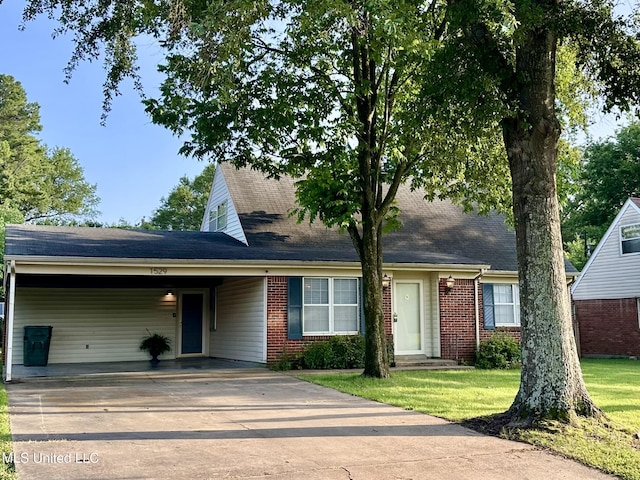 1529 Ticonderoga Dr, Southaven, MS 38671 - view of front facade with concrete driveway, an attached carport, a front lawn, brick siding, and roof with shingles