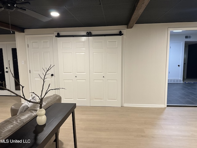 1529 Ticonderoga Dr, Southaven, MS 38671 - office with light wood-type flooring, a barn door, baseboards, and a ceiling fan