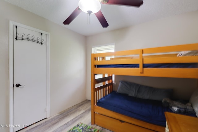 bedroom with light wood-type flooring and ceiling fan
