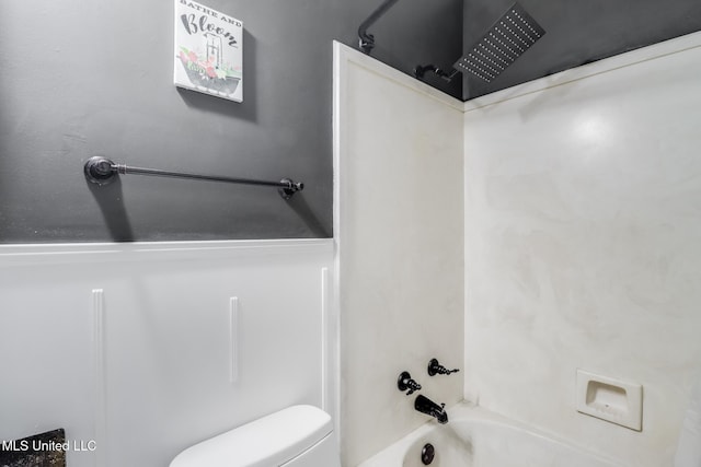 bathroom featuring toilet and shower / washtub combination