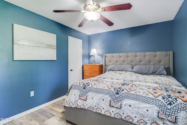 bedroom with wood finished floors, baseboards, and ceiling fan