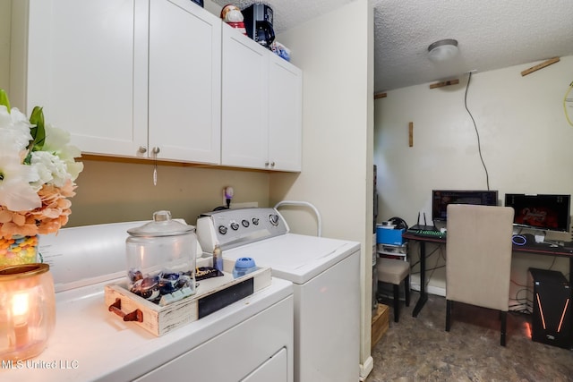 washroom featuring cabinet space, washing machine and dryer, and a textured ceiling