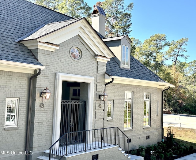 24 Waterstone Pl, Jackson, MS 39211 - entrance to property with roof with shingles, a chimney, crawl space, and brick siding