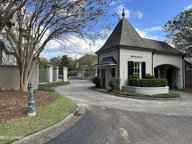 24 Waterstone Pl, Jackson, MS 39211 - exterior space featuring a gate, fence, a shingled roof, and driveway
