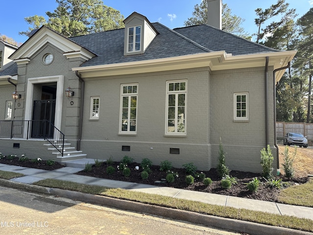 24 Waterstone Pl, Jackson, MS 39211 - view of front facade with a chimney, a shingled roof, crawl space, and brick siding