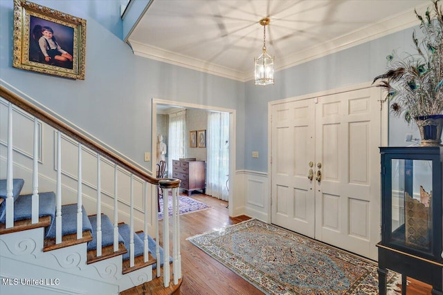 350 Whitfield Rd, Brandon, MS 39042 - foyer entrance featuring ornamental molding, stairway, a wainscoted wall, wood finished floors, and a chandelier
