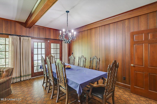 350 Whitfield Rd, Brandon, MS 39042 - dining space featuring wooden walls, a chandelier, beamed ceiling, and plenty of natural light