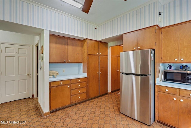 350 Whitfield Rd, Brandon, MS 39042 - kitchen featuring stainless steel appliances, light flooring, brown cabinets, light countertops, and ceiling fan