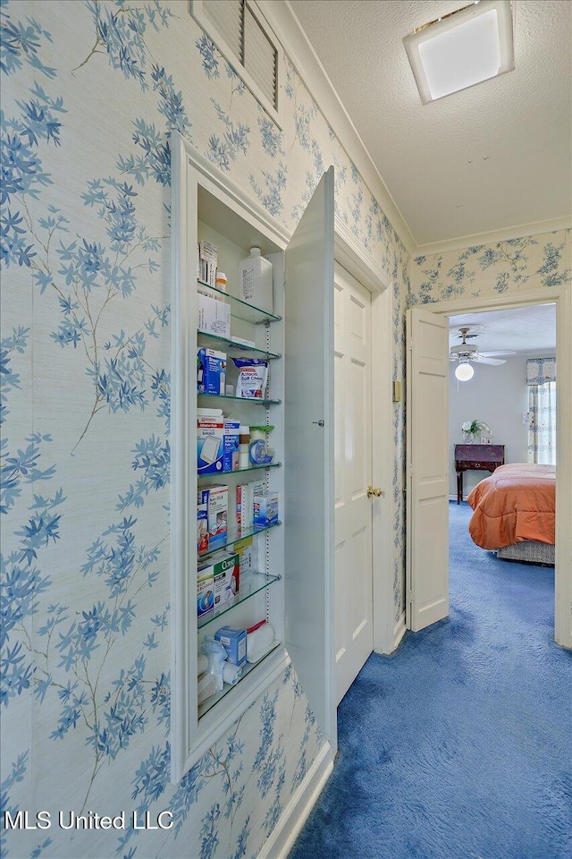 350 Whitfield Rd, Brandon, MS 39042 - hallway with wallpapered walls, carpet floors, crown molding, and a textured ceiling