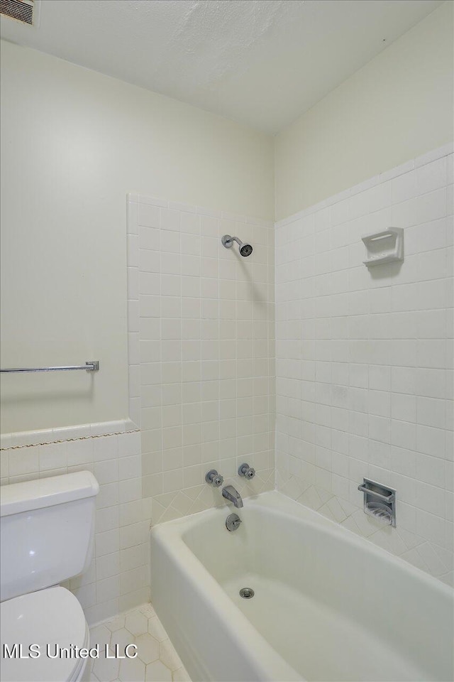 350 Whitfield Rd, Brandon, MS 39042 - bathroom featuring tile walls, tub / shower combination, wainscoting, and tile patterned flooring