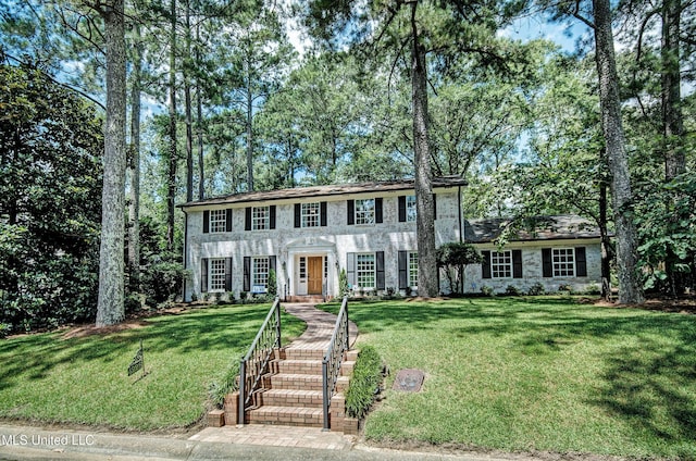 colonial inspired home with a front yard