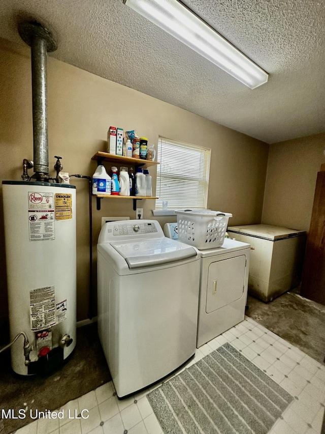 laundry area featuring independent washer and dryer, a textured ceiling, and water heater