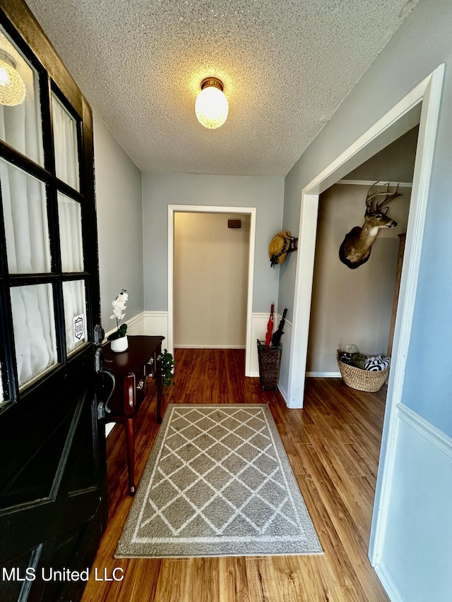 entrance foyer featuring wood-type flooring and a textured ceiling