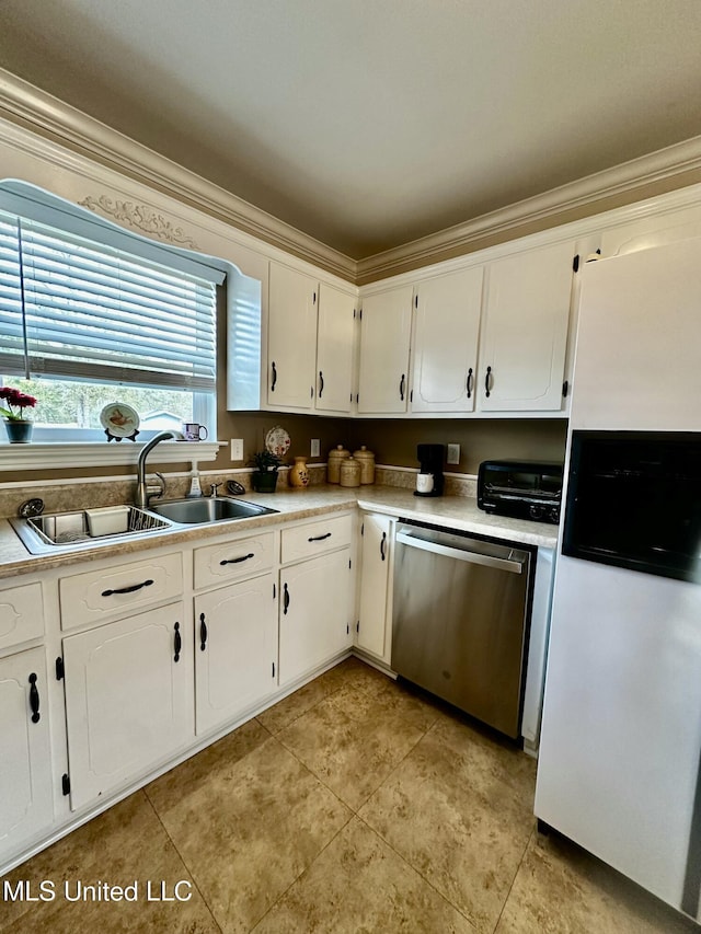 kitchen with crown molding, dishwasher, white fridge, and sink