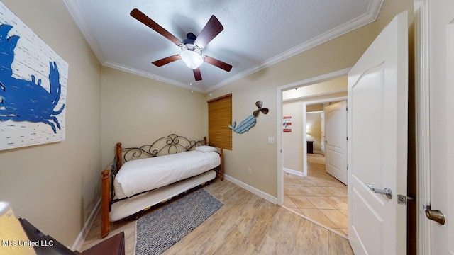 1200 Beach Dr Unit 806, Gulfport, MS 39507 - bedroom featuring light wood-style flooring, crown molding, a ceiling fan, and baseboards