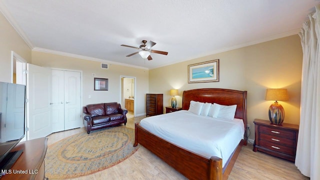 1200 Beach Dr Unit 806, Gulfport, MS 39507 - bedroom featuring light wood-type flooring, crown molding, a closet, and ensuite bathroom