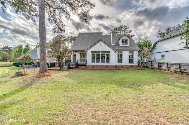 back of property featuring a lawn