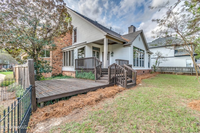 exterior space with a lawn and a wooden deck