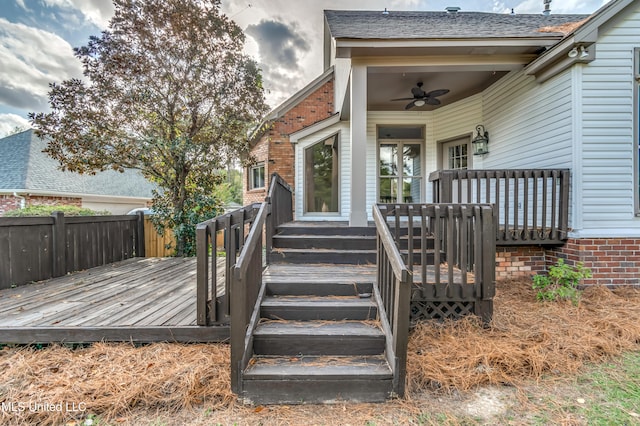 entrance to property with a deck and ceiling fan