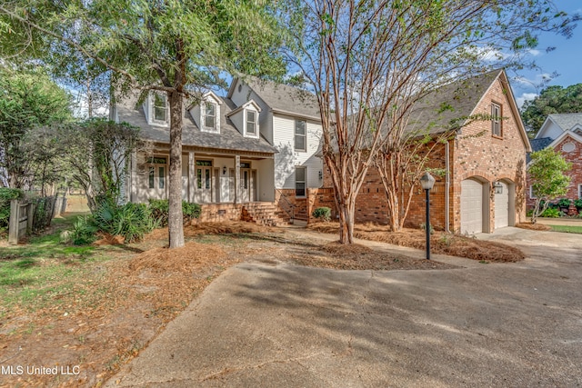 view of front of house with a porch and a garage