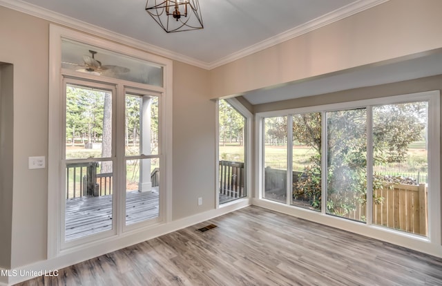 unfurnished sunroom featuring a chandelier