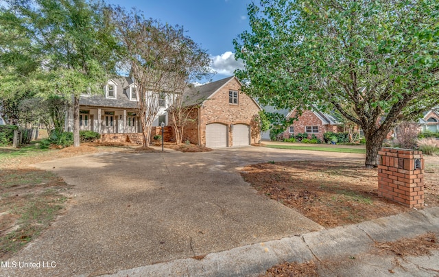 view of front of property with a garage and covered porch