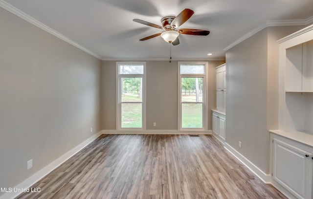 spare room featuring ornamental molding, light hardwood / wood-style flooring, and ceiling fan