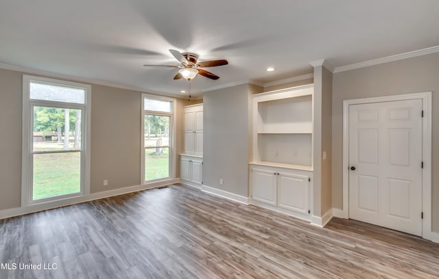 unfurnished living room with crown molding, ceiling fan, and light hardwood / wood-style flooring