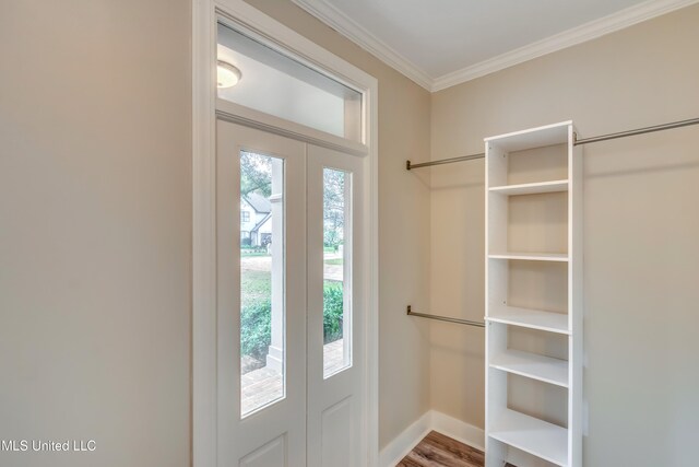 doorway to outside with hardwood / wood-style floors and crown molding