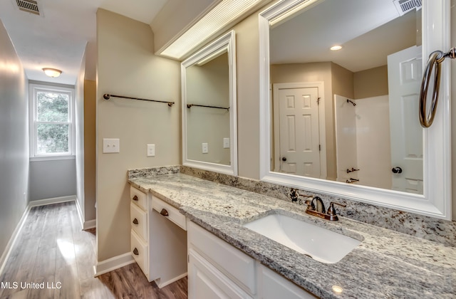 bathroom with hardwood / wood-style floors and vanity