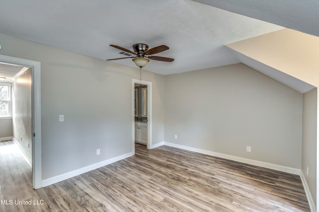 interior space featuring ceiling fan, lofted ceiling, and light hardwood / wood-style floors