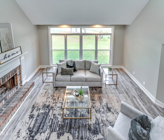 living room with a fireplace, hardwood / wood-style floors, and plenty of natural light